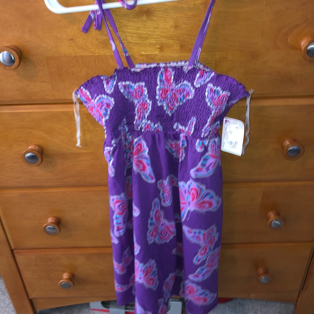 A summer time dress with butterflies on it